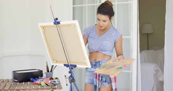 Artistic Young Woman Working On a Painting
