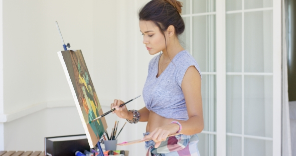 Attractive Woman Artist Painting On Her Patio