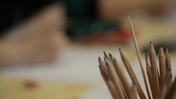 Unfocused View Of Male Student Drawing Picture.