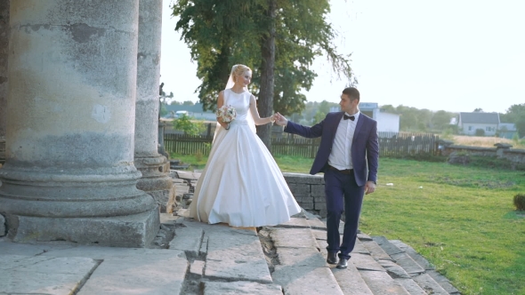 Wedding Couple Walking Near The Castle And Whirling