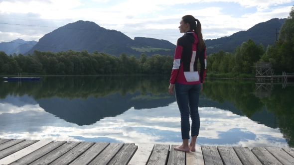 Woman Enjoying The View Of Mountains And Lake