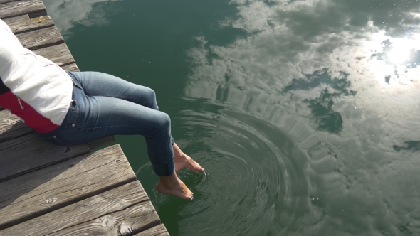 Cloud Reflection In On The Clear Water Where Woman Dips Her Feet