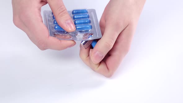 Doctor Takes Blue Medical Pills on Hand, Close Up