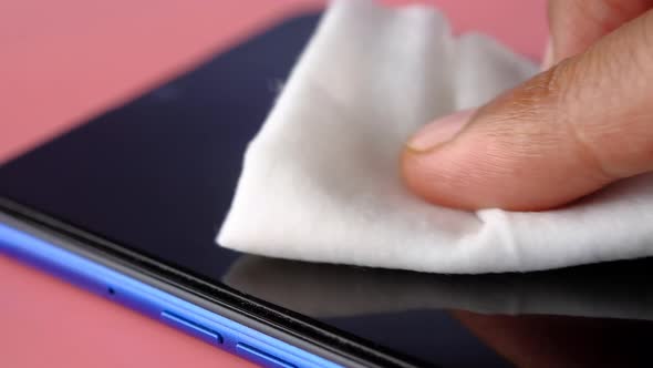 Man Hand Cleaning Mobile Phone Display for Preventing Virus 