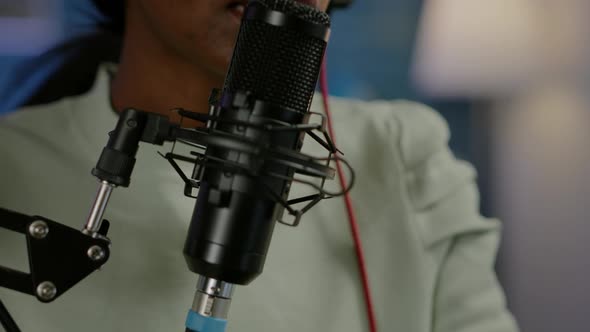 Close Up of African Influencer Answering Questions While Talking Into Microphone