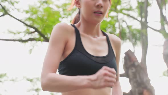 Asian young beautiful sport woman exercise by running on street in public park for health in garden.