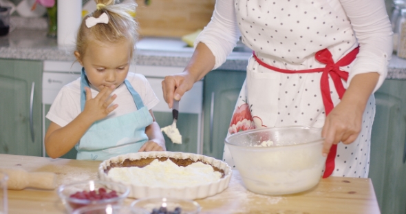 Little Girl Watching The Baking With Anticipation