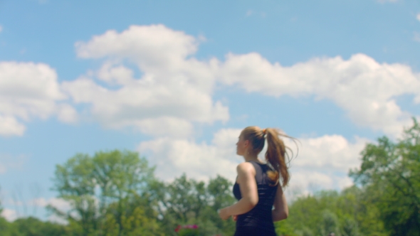 FItness Woman Running In  At Background Of Blue Sky With Clouds