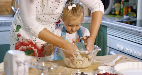 Cute Little Girl Kneading Baking Ingredients