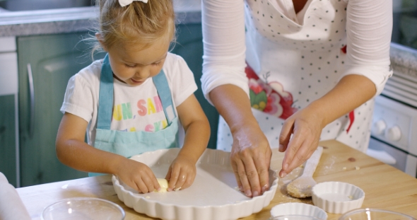 Cute Little Girl Greasing a Baking Dish