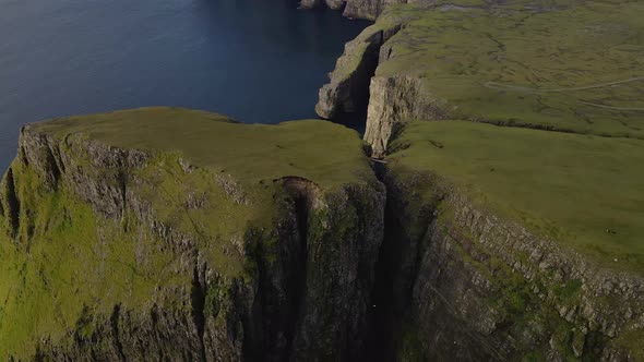 Drone Flight Rising Over Cliff Edges On Coastline