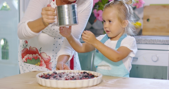 Adorable Little Girl Engrossed In Baking a Pie