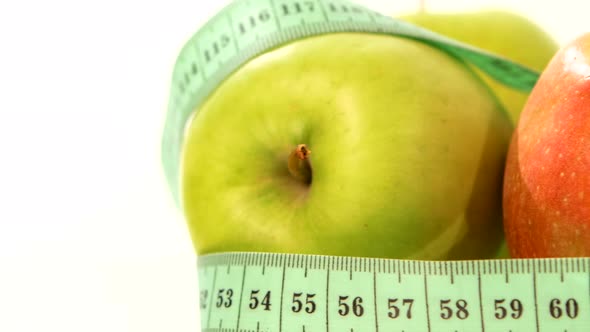 Green, Fresh Apple with Measuring Tape on White, Rotation, Close Up