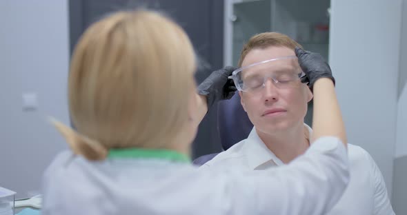 Doctor Puts on Goggles to the Patient