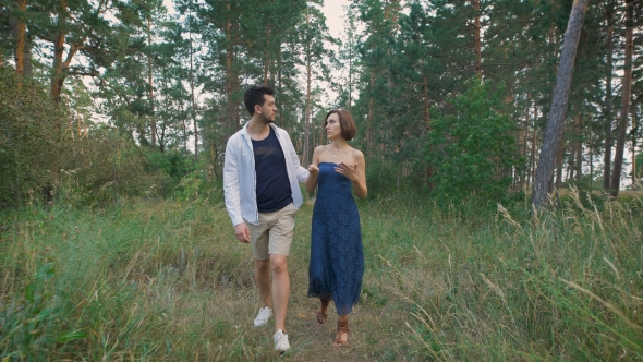 Young Couple Walking In The Woods Or The Park, Not Far From His Home.