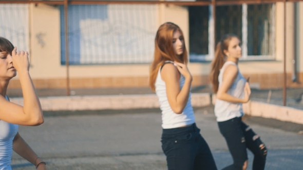 Girls In White T-shirts Dancing On The Playground In 