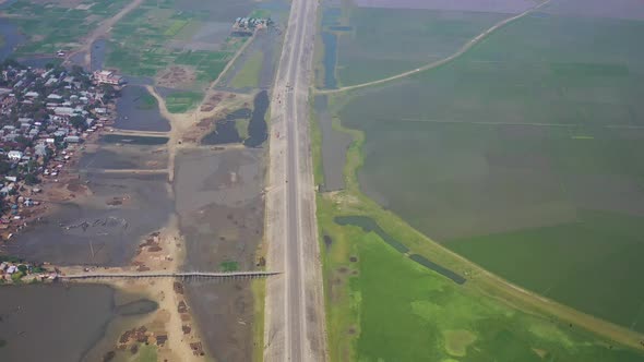 Aerial view of a road among the fields in Sapahar, Rajshahi, Bangladesh.