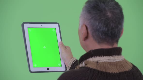 Closeup Rear View of Happy Mature Japanese Man Using Digital Tablet