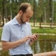 Man Using Mobile Smart Phone in Park - VideoHive Item for Sale