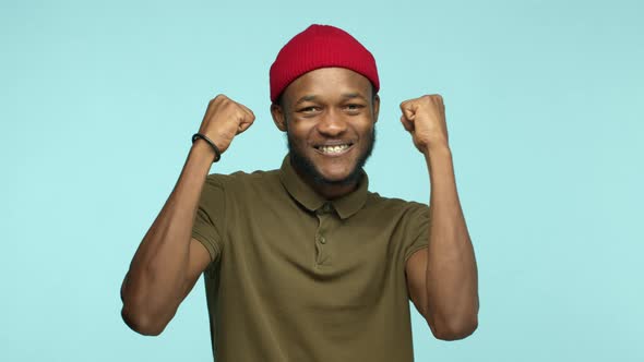 Slow Motion of Happy African American Man Winning Prize and Celebrating Making Fist Pump Gesture and