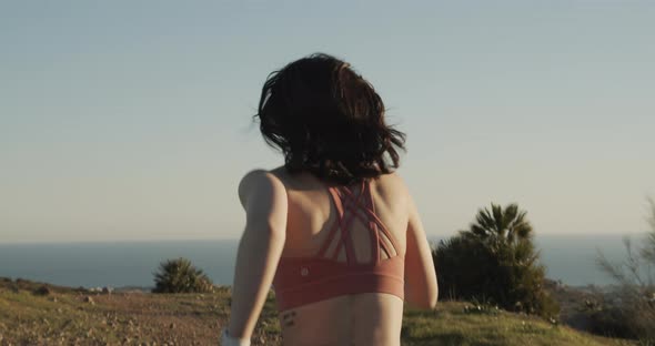 Woman Running Along Hilltop In Sportswear