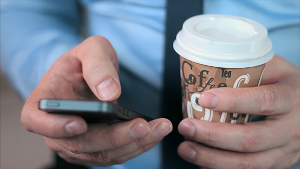 Businessman Hands with Smartphone and Coffee