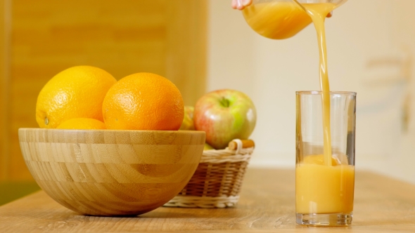 Orange Juice Pouring Into Glass