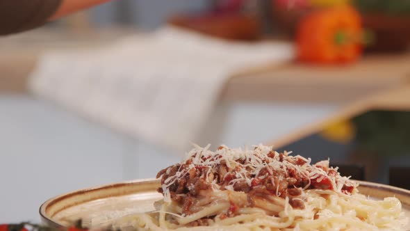 Adding Parmesan to Spaghetti Bolognese