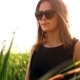 Girl Black Sunglasses Goes Across The Field Through Tall Grass Portrait - VideoHive Item for Sale