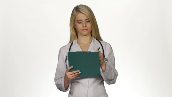 Health Worker Takes Notes On Clipboard. White