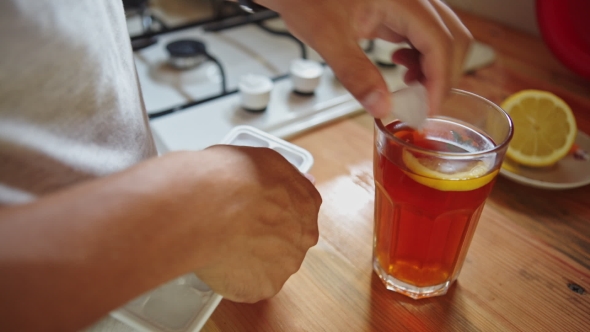 Man In The Kitchen Preparing Tea With Ice