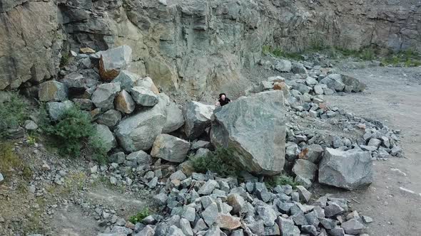 Happy male tourist climbing on the rocky mountains.