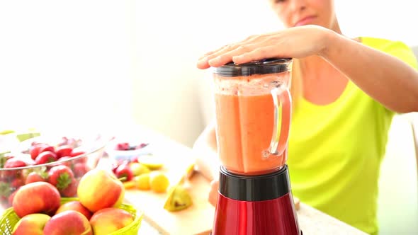 Mature woman preparing a smoothie	