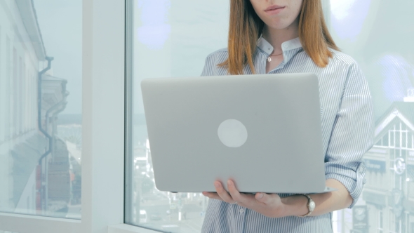 Unrecognizable Businesswoman Hands Working On Laptop Computer At Modern Bright Office.