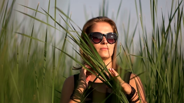 Girl In Black Sunglasses Straightens Hair