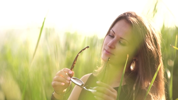 Girl Among The High Grass Wears Black Sunglasses