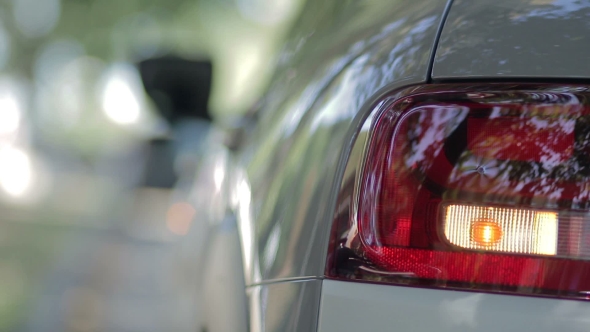 Woman Opening Car Gas Tank Cap