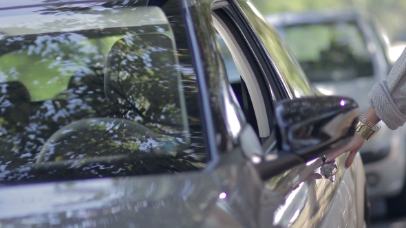 Young Female Driver Getting In The Car alt