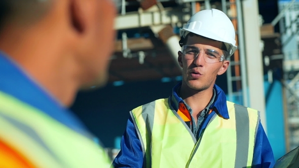 Industrial Engineer And Worker Discussing In Factory. 