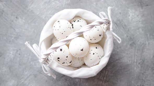 Composition of White Traditional Dotted Easter Eggs in White Wicker Basket