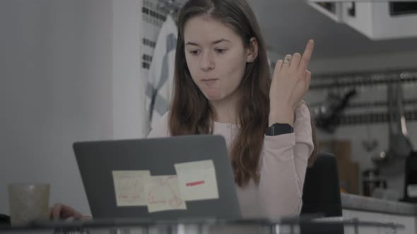 Close up of a woman using computer at home.