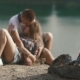 Loving Young Teenager Pair Embraces While Relaxing At Campsite On Forest Rivershore - VideoHive Item for Sale