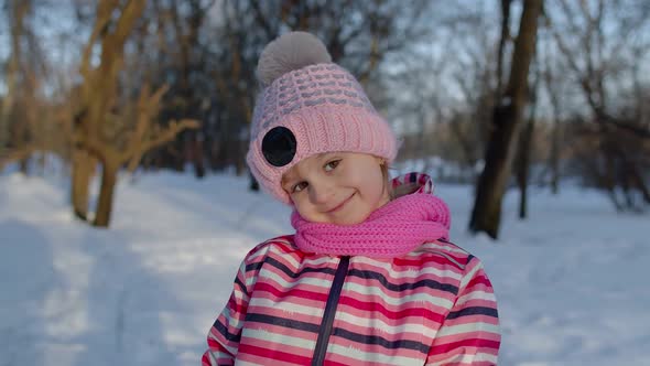 Smiling Child Kid Walking Having Fun Relaxing Looking Around on Snowy Road in Winter Park Forest