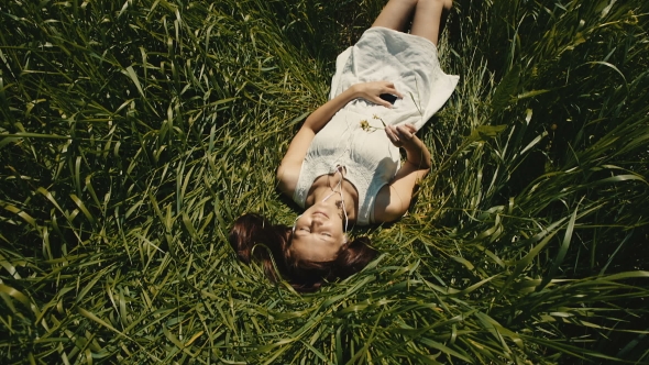 Beautiful Woman Resting On The Meadow