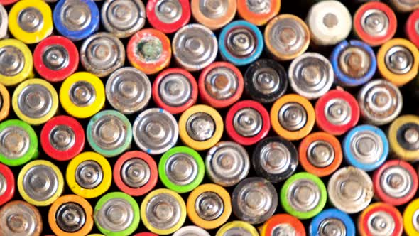 Old used discarded AA cells and other electric batteries from different manufacturers