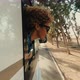 beautiful caucasian young woman travel outside the camper van with wind in the curly hair travel - VideoHive Item for Sale