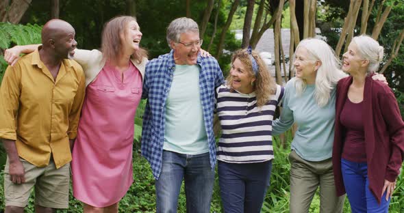 Animation of happy diverse female and male senior friends talking and having fun together in garden