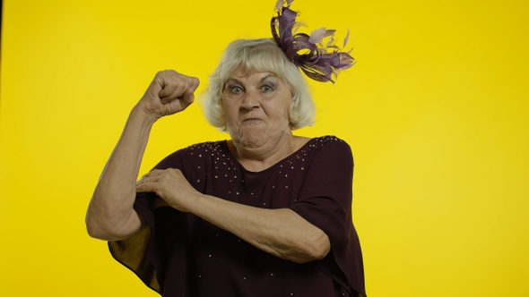 Senior Woman Showing Biceps, Looking Confident, Feeling Power Strength To Fight for Female Rights
