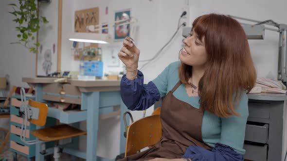 Young Entrepreneur On Making Jewels For Pet Is Wearing Apron In Her Workplace