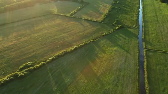 The River Flows In The Green Valley. Ameliorative Channels Are Visible. In The Light Of The Bright S